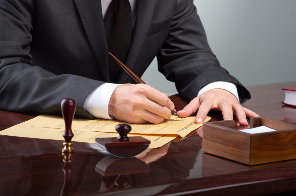 Businessman writing testament at notary public office ley segunda oportunidad