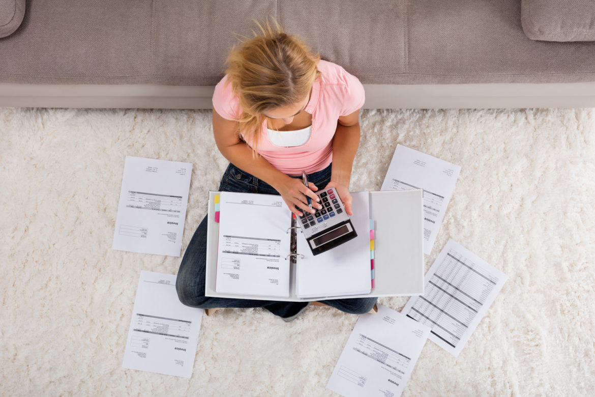 Woman Calculating Invoice facturas