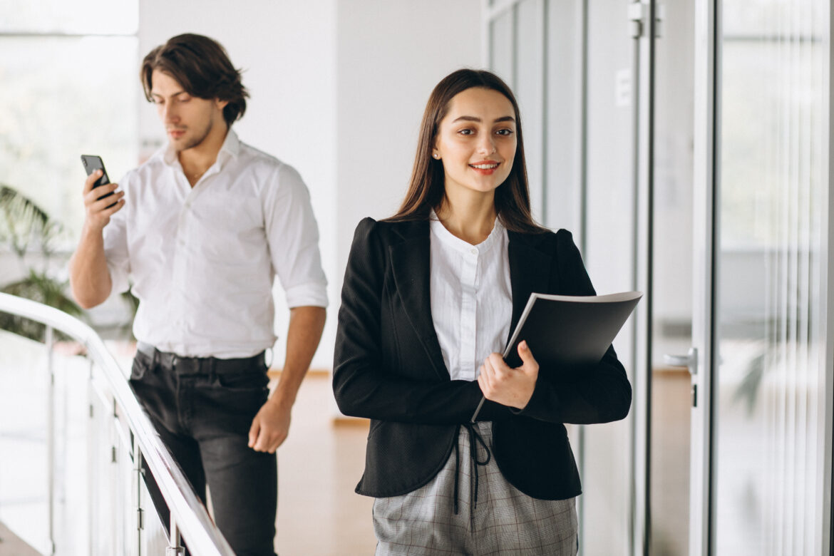 Two collegues working in a business center AJE